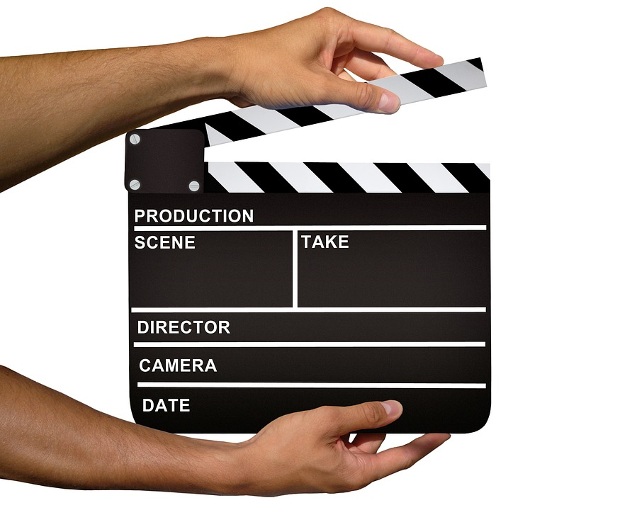 Two hands holding a clapperboard