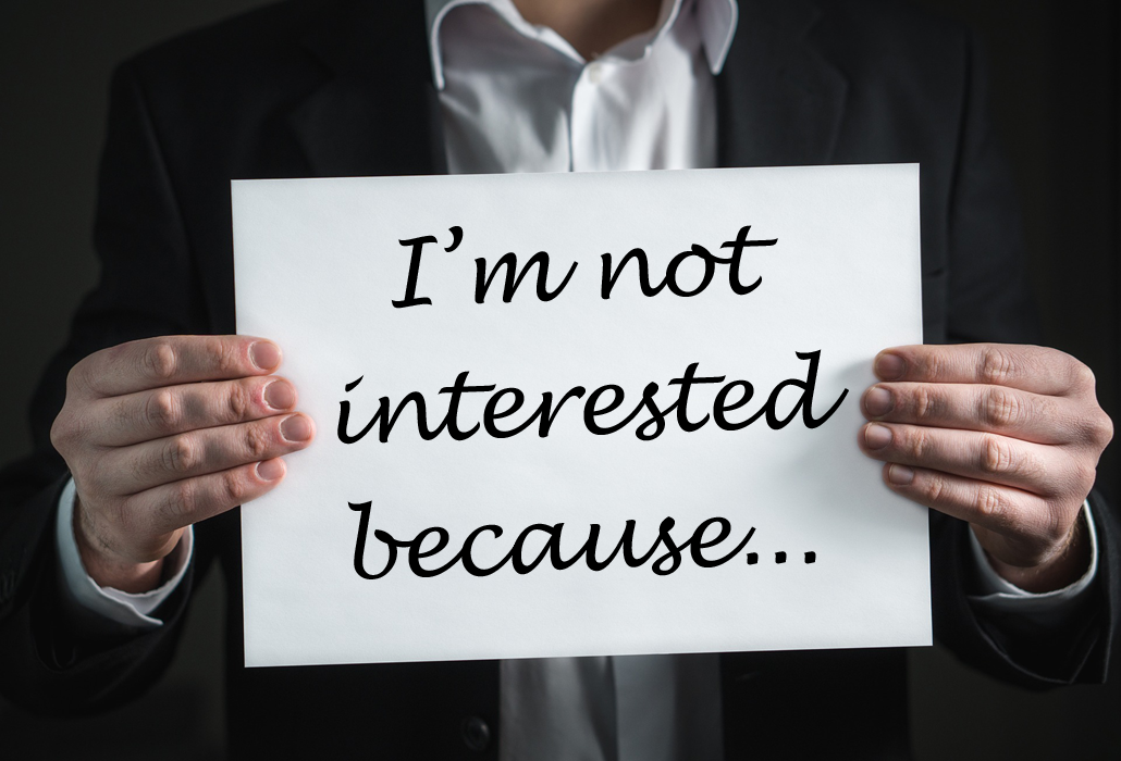Person holding a sign saying "I'm not interested because..."